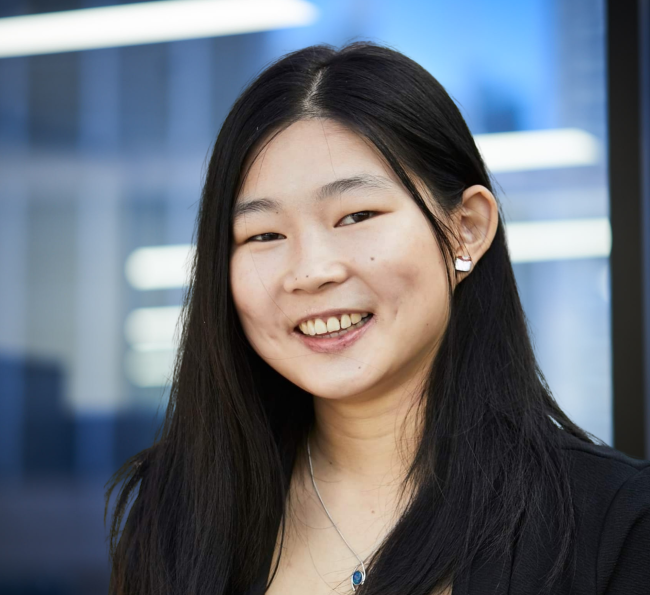 Professional headshot of a team member in an office environment
