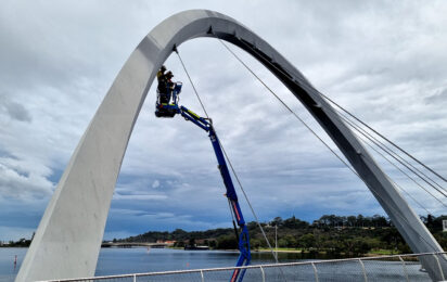 Engineering on EWP mounted on barge inspecting Elizabeth Quay Pedestrian Bridge.
