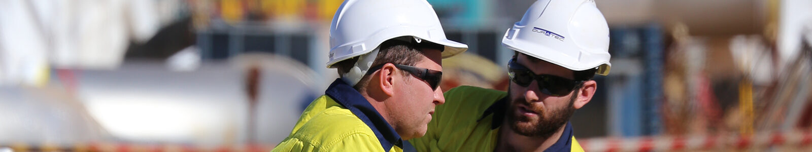 Our-Company-Banner-Website-two-men-in-hardhats-blurry-background