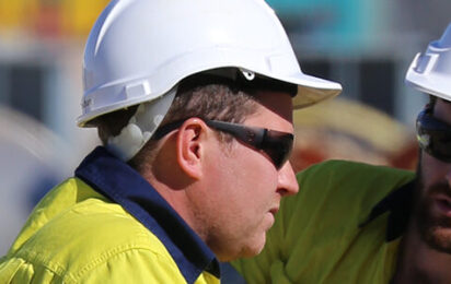 Our-Company-Banner-Website-two-men-in-hardhats-blurry-background