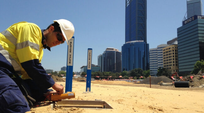 Technician installing a cathodic protection system to mitigate corrosion in reinforced concrete infrastructure.