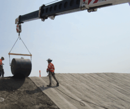 Engineers installing Concrete Canvas roll on slope