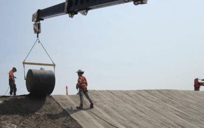 Engineers installing Concrete Canvas roll on slope