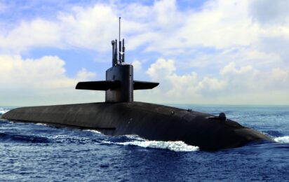 Naval submarine on open blue sea surface